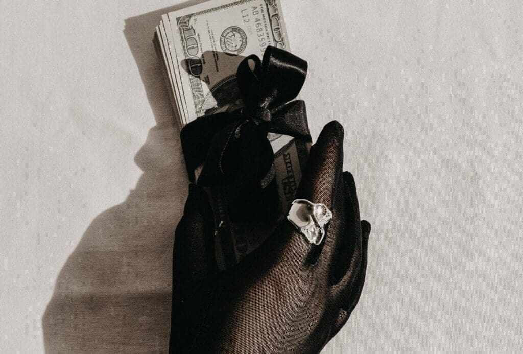 Woman holding money in her hand made from residual income streams